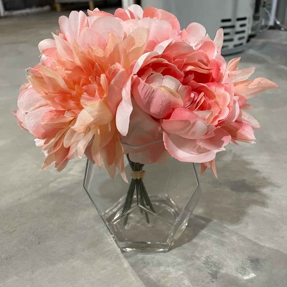 Pink peony arrangement in glass pot
